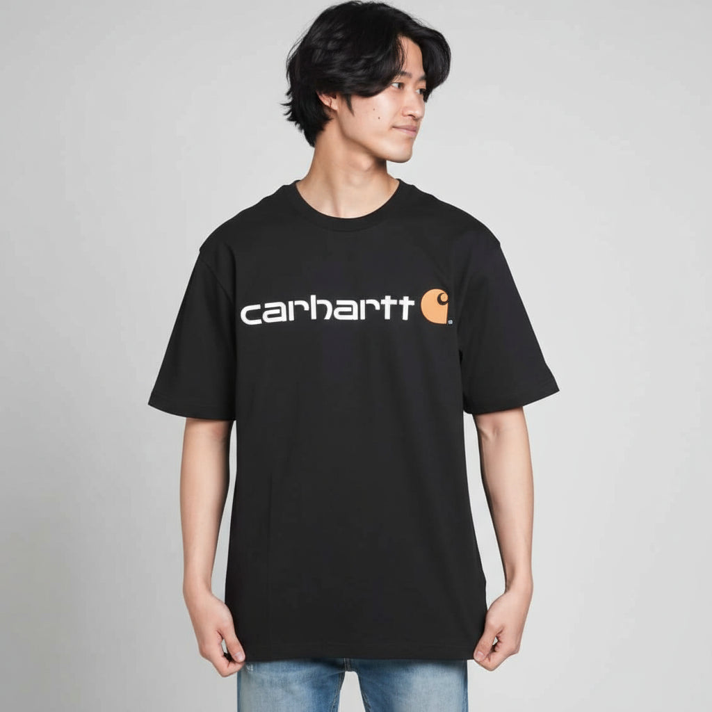 Person wearing a black Carhartt t-shirt on a white background