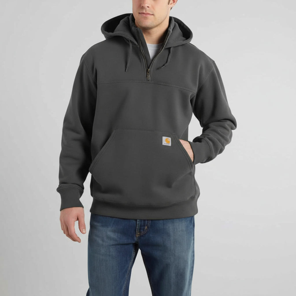 Person wearing a dark gray hoodie with a brand logo on a white background