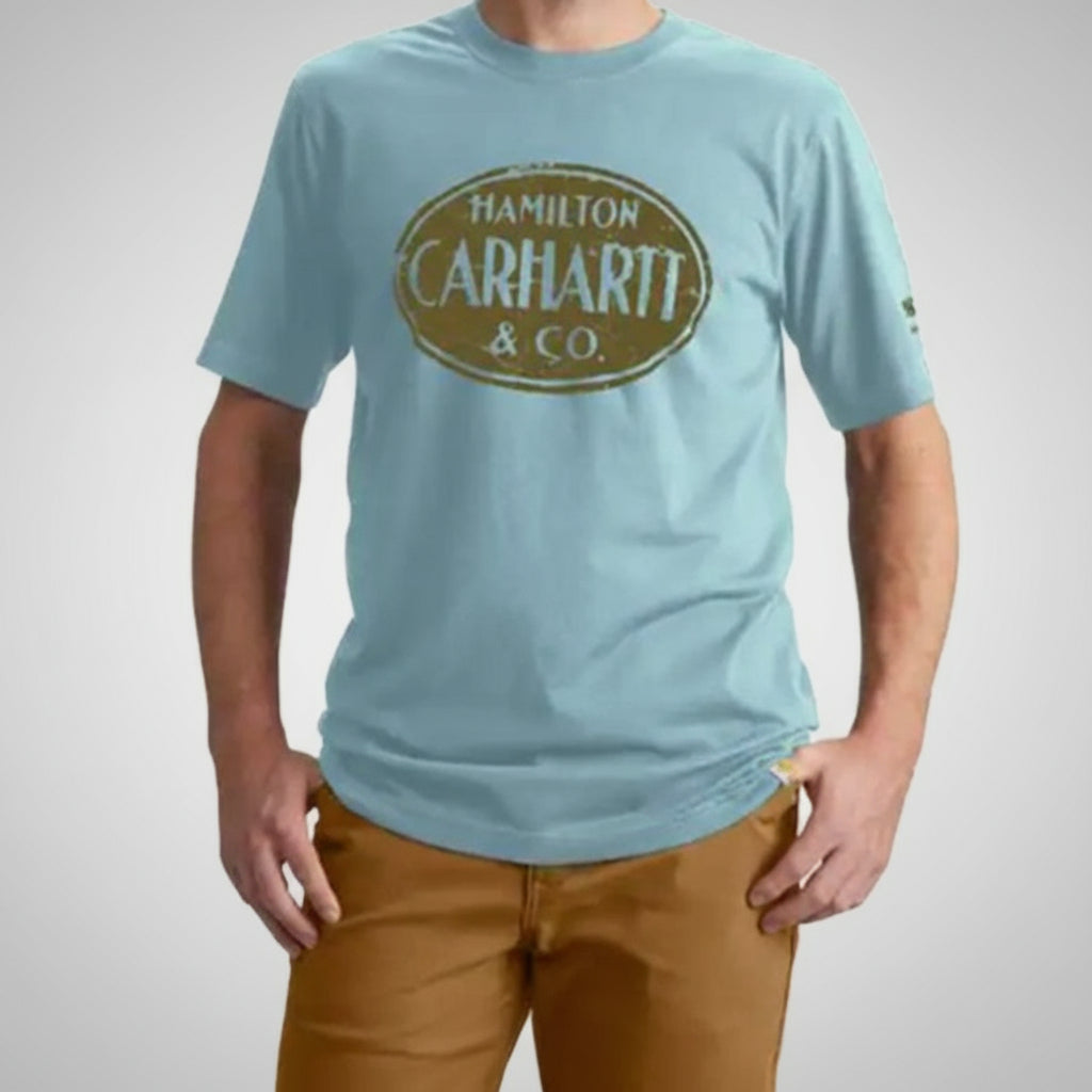 Person wearing a light blue t-shirt with 'Hamilton Carhartt & Co.' logo on a white background