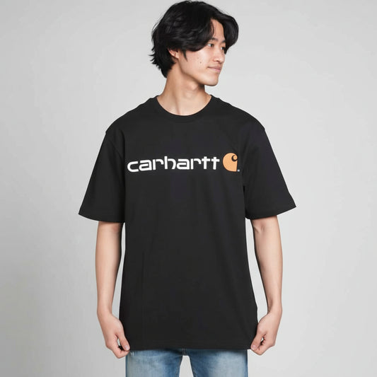 Person wearing a black Carhartt t-shirt on a white background
