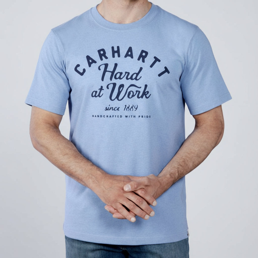Person wearing a light blue Carhartt t-shirt with text on a white background