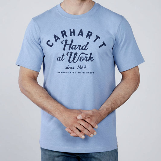 Person wearing a light blue Carhartt t-shirt with text on a white background